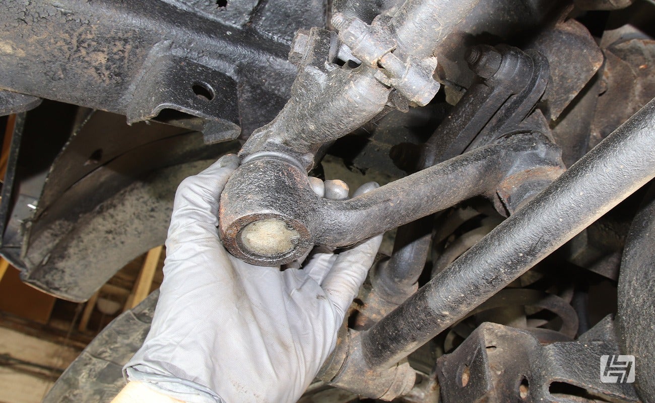 mechanic inspects steering linkage on Land Rover Defender