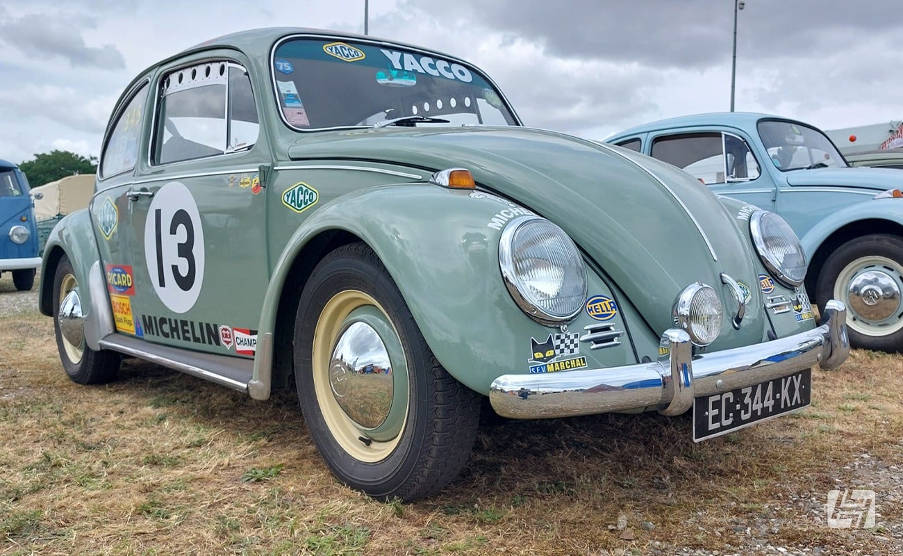 Green VW Beetle with vintage sign writing at Le Mans Classic 2023