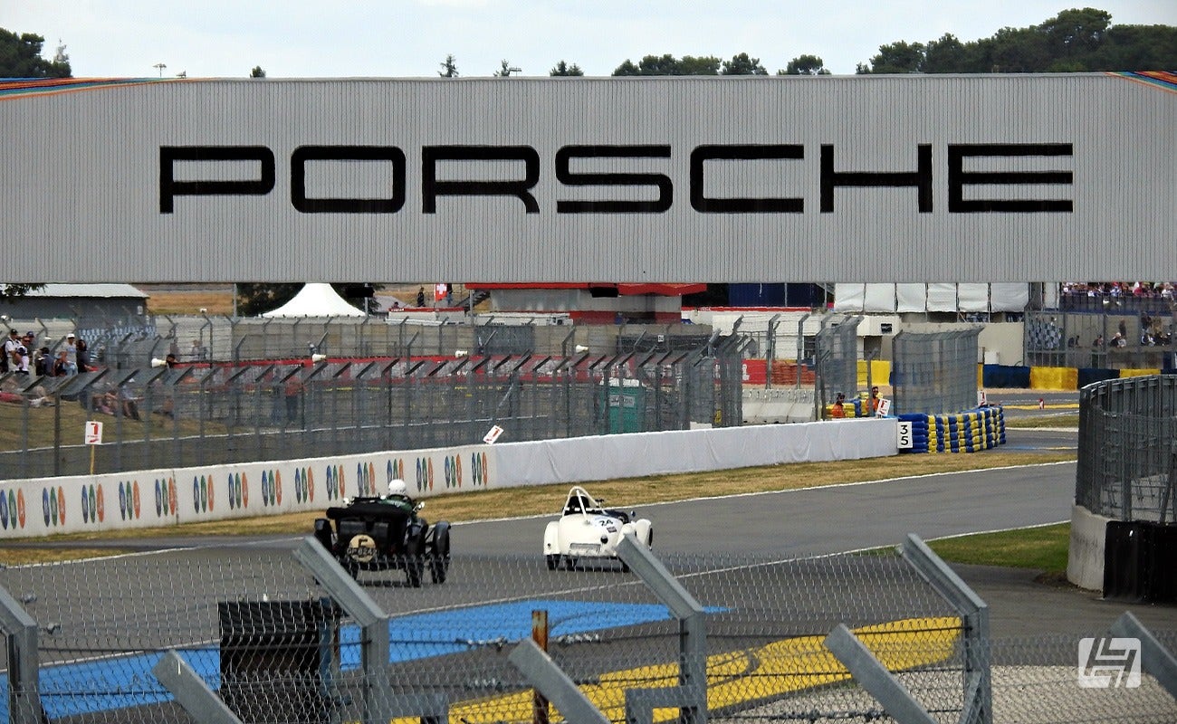 Vintage race cars at Classic Le Mans 2023 under the Porsche bridge
