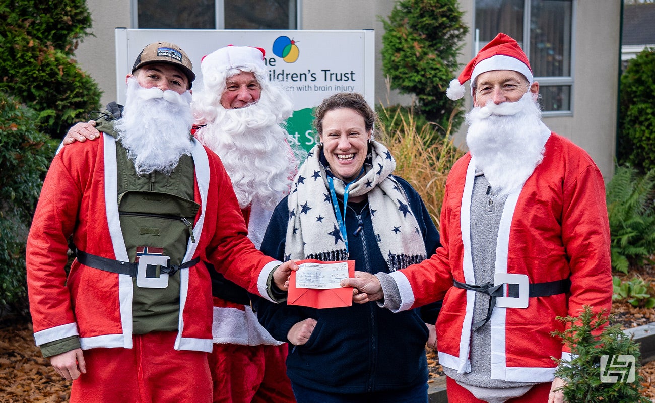 Santa Cruisers hand over cheque to Keren at The Children's Trust