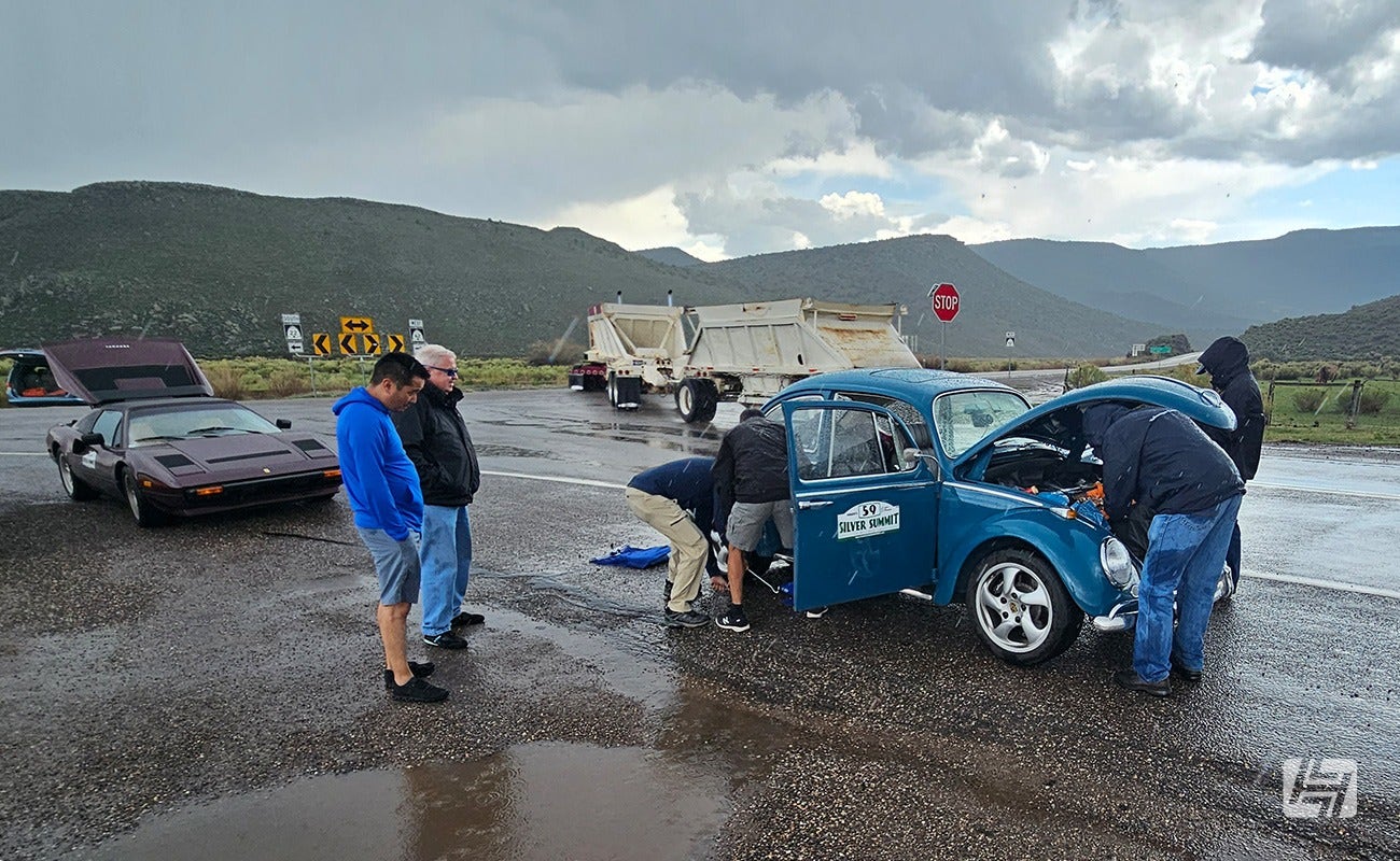 Richard and fellow competitors try and fix his car.