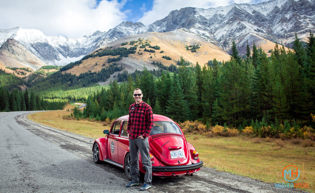 Dave Hord from Classic Car Adventures with his red German look VW Beetle on a road trip. 