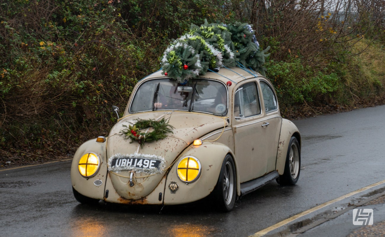 Beige patina VW Beetle with Christmas tree on the roof rack