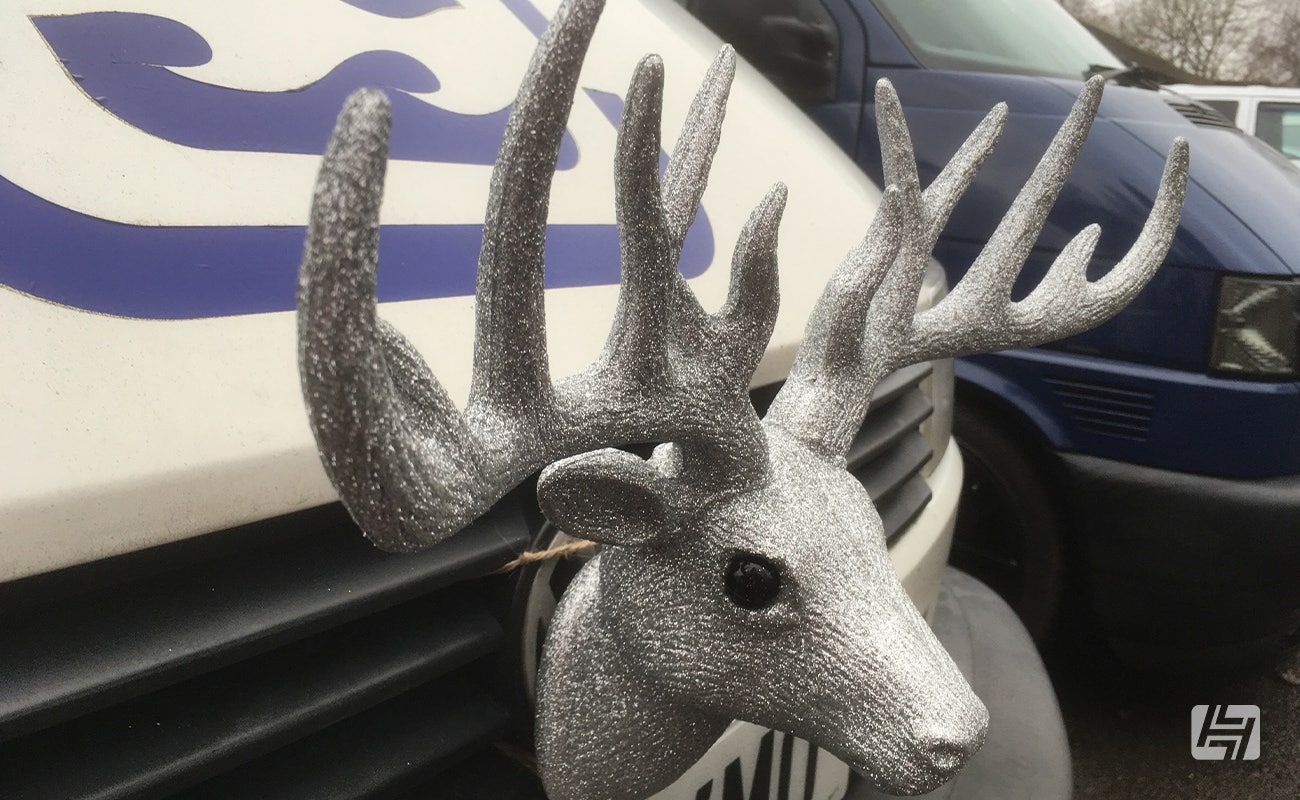 White VW T4 with silver stag head mounted on the front grille