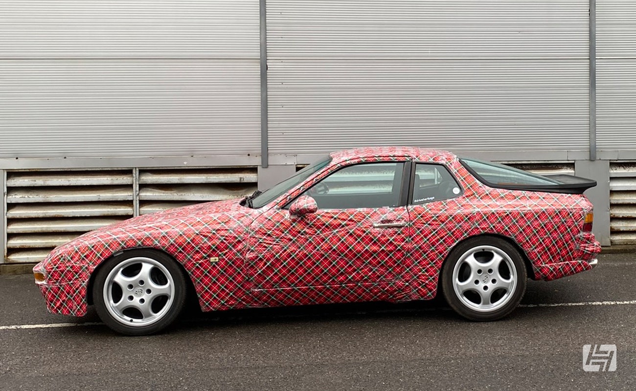 side photo of Porsche 944 completely covered in tartan wrapping paper