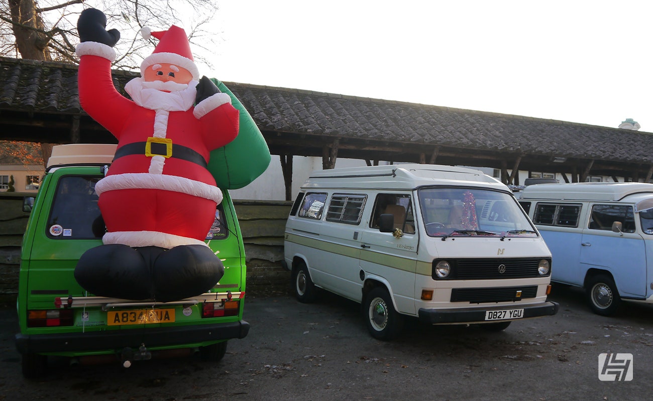 Green VW Type 25 with large inflatable Santa on the bike rack 