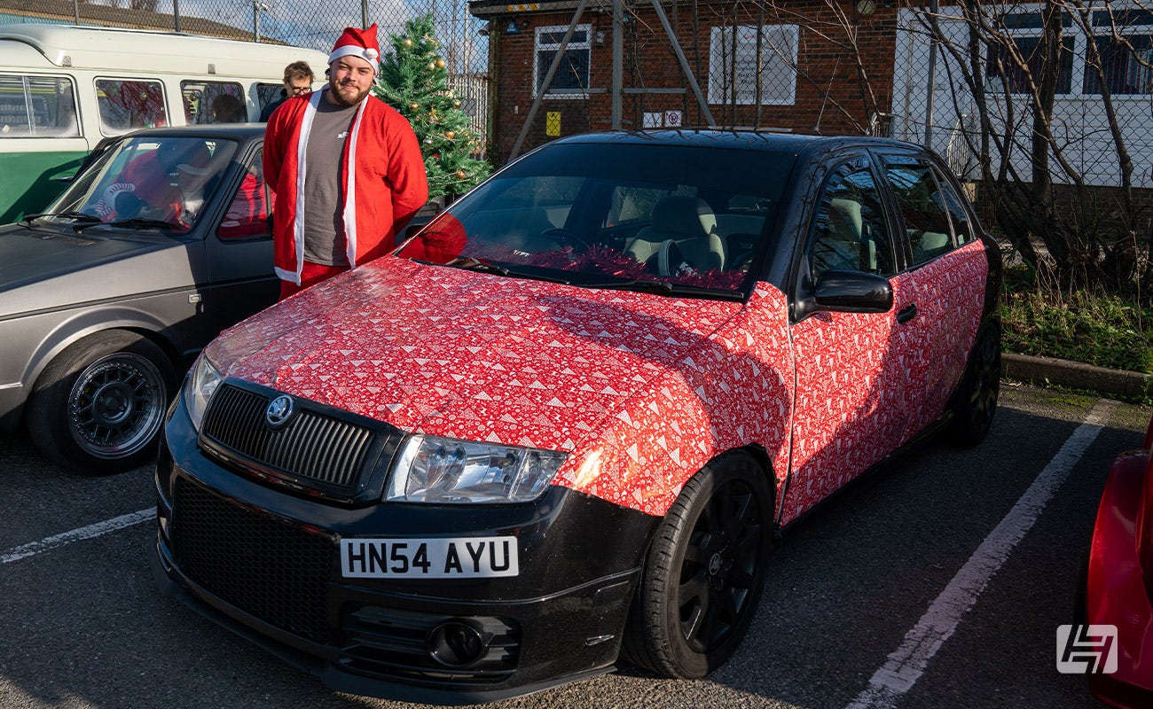 Black Skoda Fabia VRS with Christmas wrapping paper covering the bonnet and doors