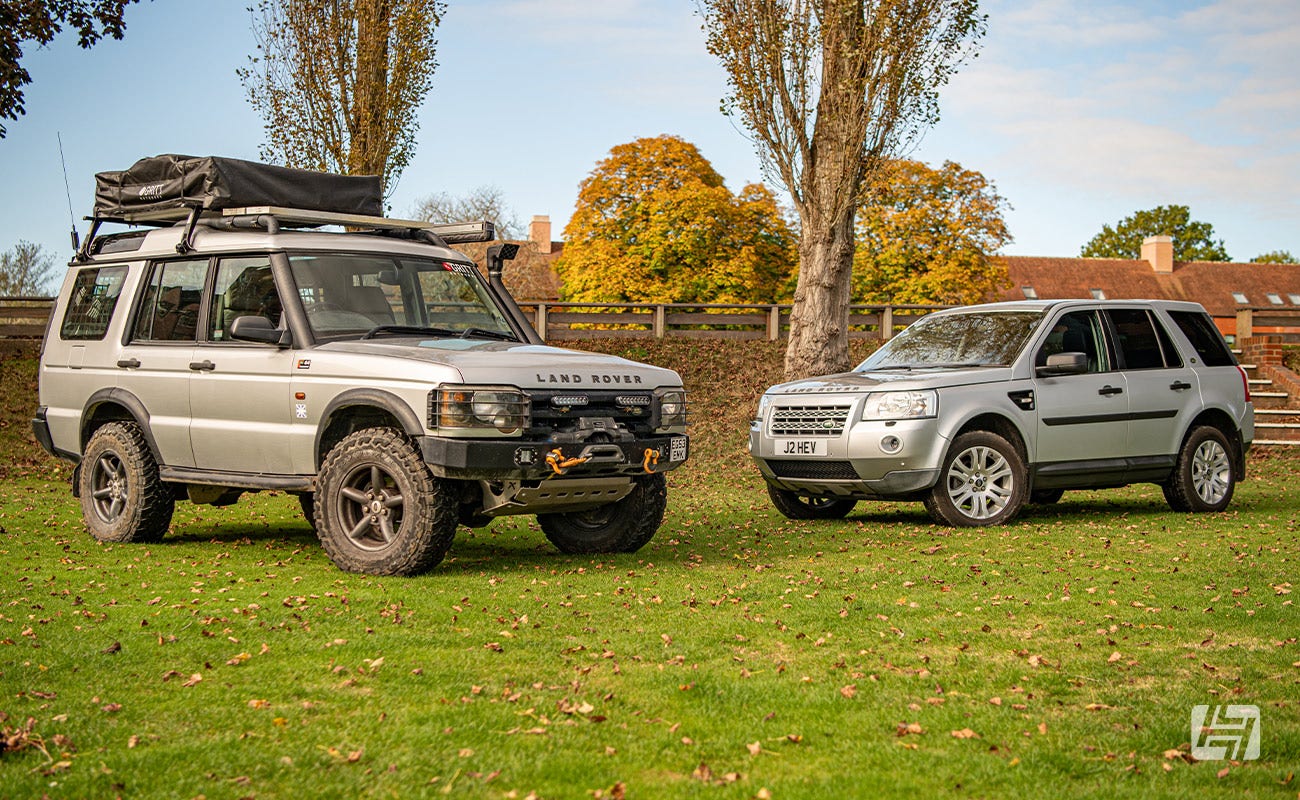 Silver Land Rover Discovery and silver Land Rover Freelander 