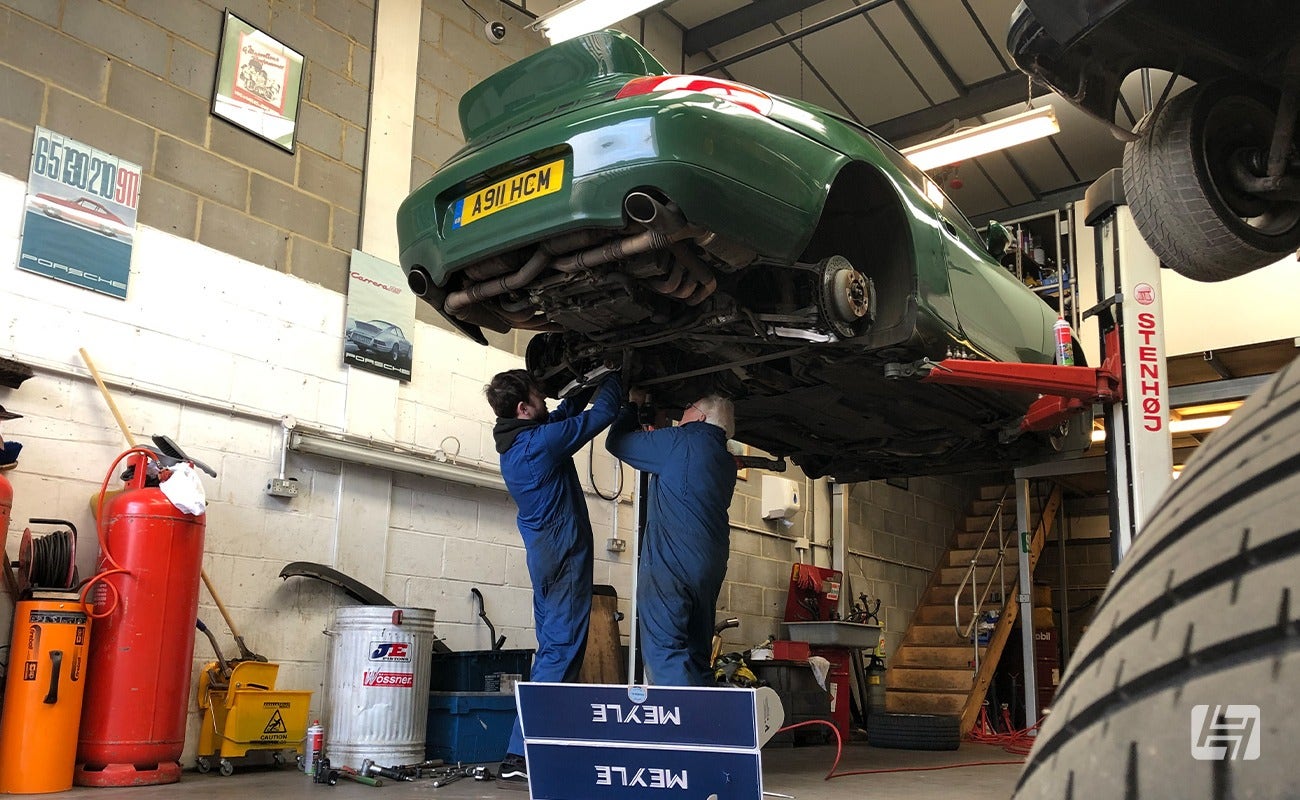 Mechanics working on green Porsche 996 Little Irish, Wrightune, 9Werks