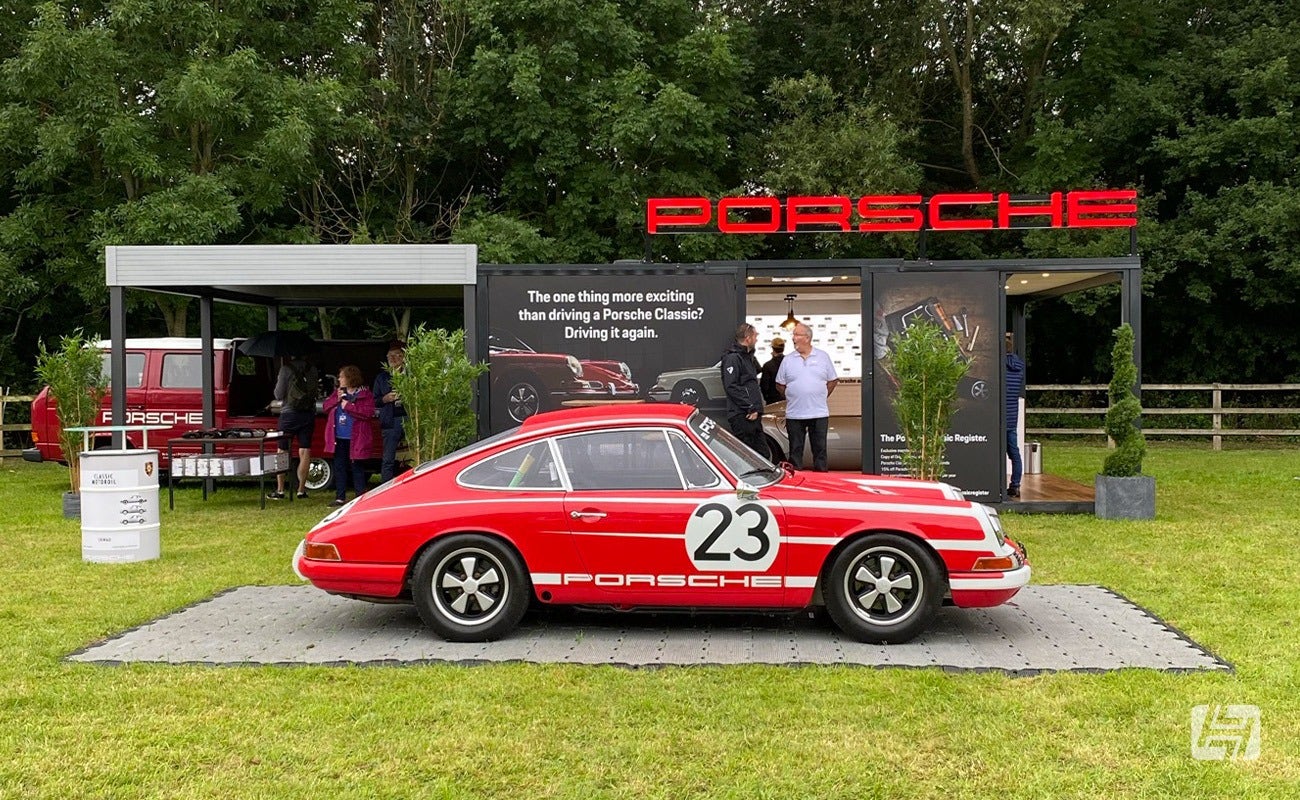 Red and White Porsche 911 parked outside Porsche Classic stand at Megaphonics