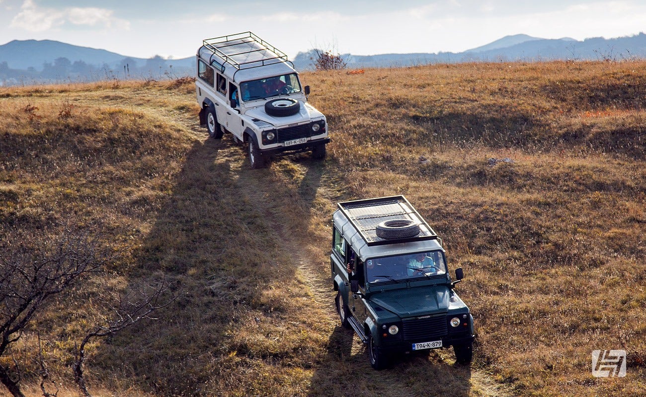 Land Rover Defenders driving off road