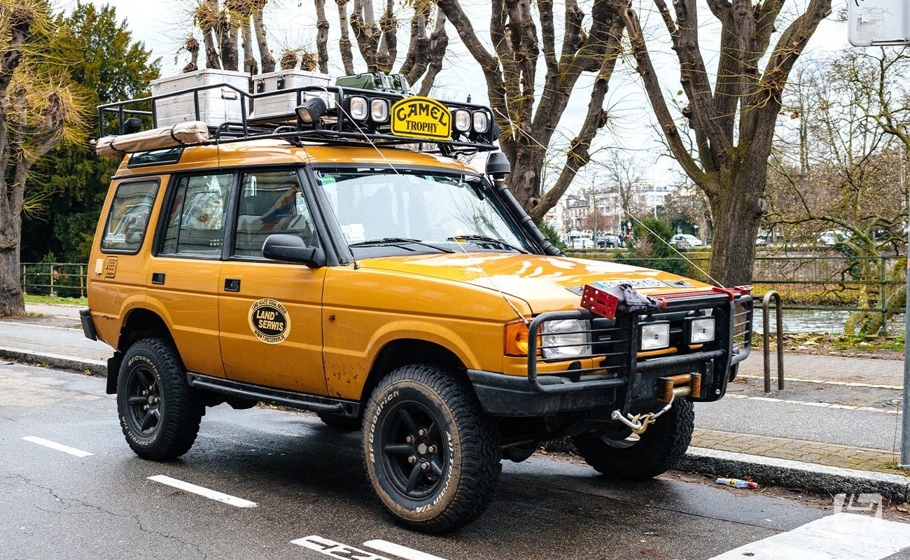 Yellow offroad Land Rover Discovery on the road