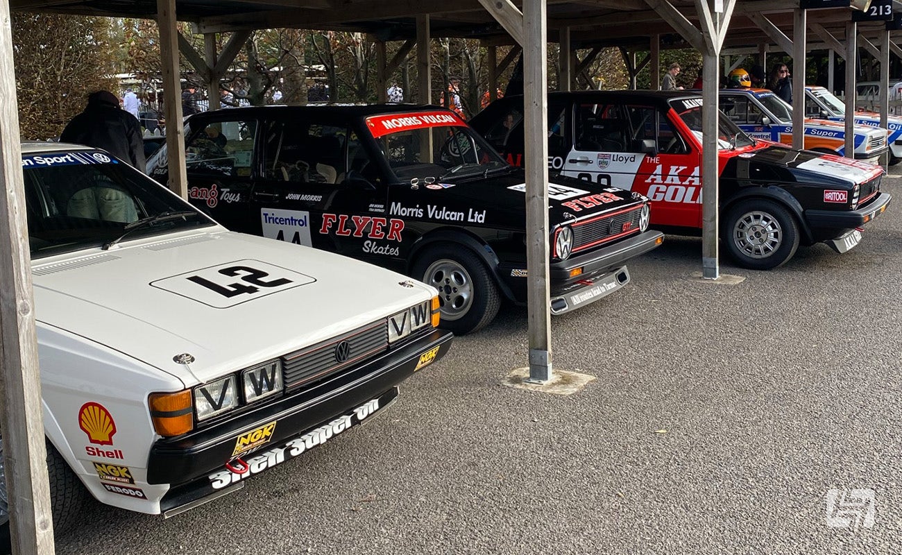 VW Scirocco Mk2 and Golf Mk1 GTI race cars in paddock at Goodwood