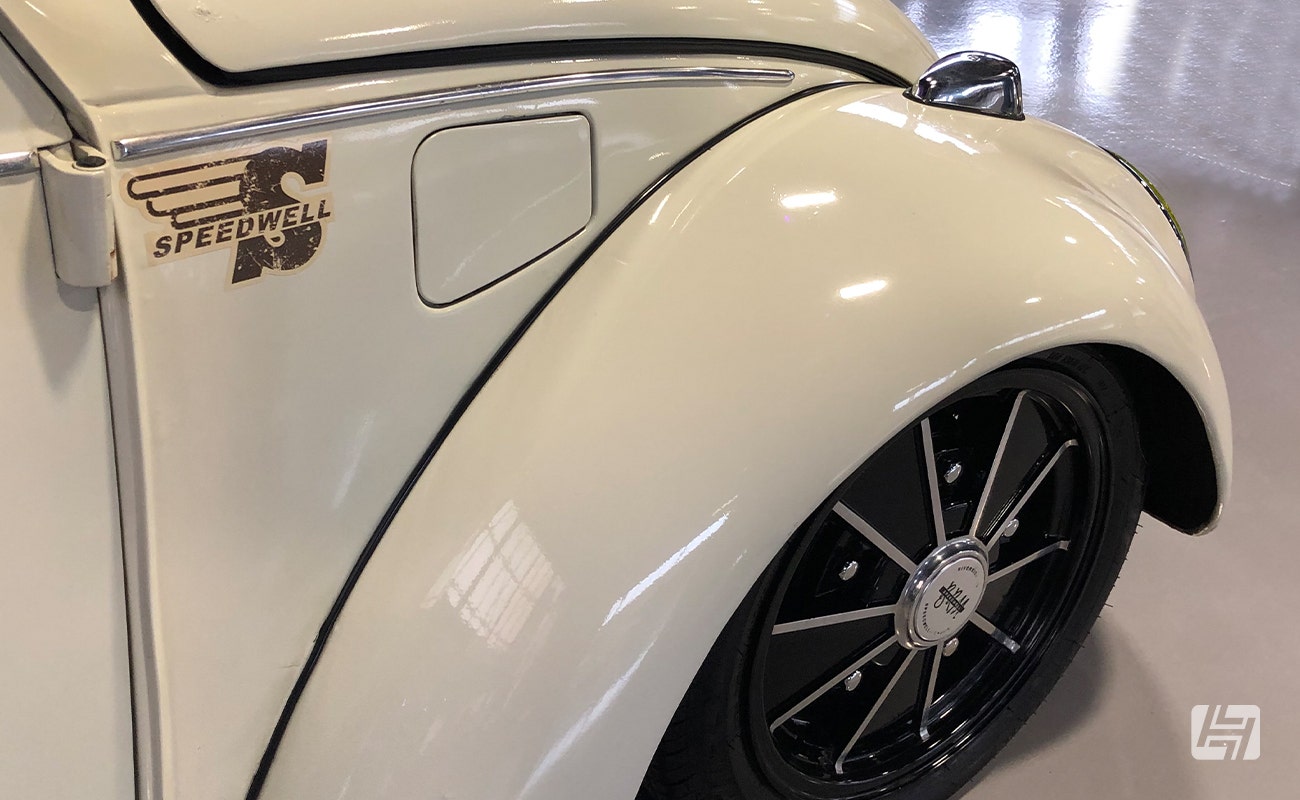 White VW Beetle with BRM wheels tucked under the wheel arch