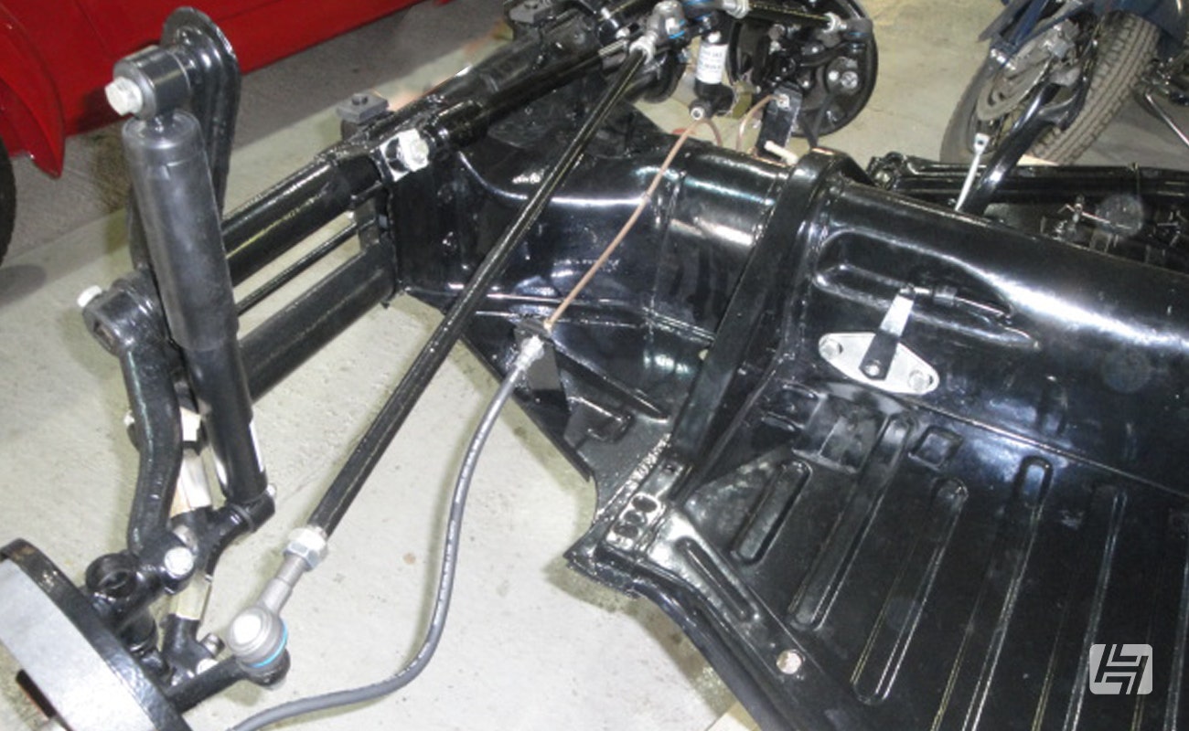 VW Beetle floorpan without body fitted, showing front axle and shock absorbers