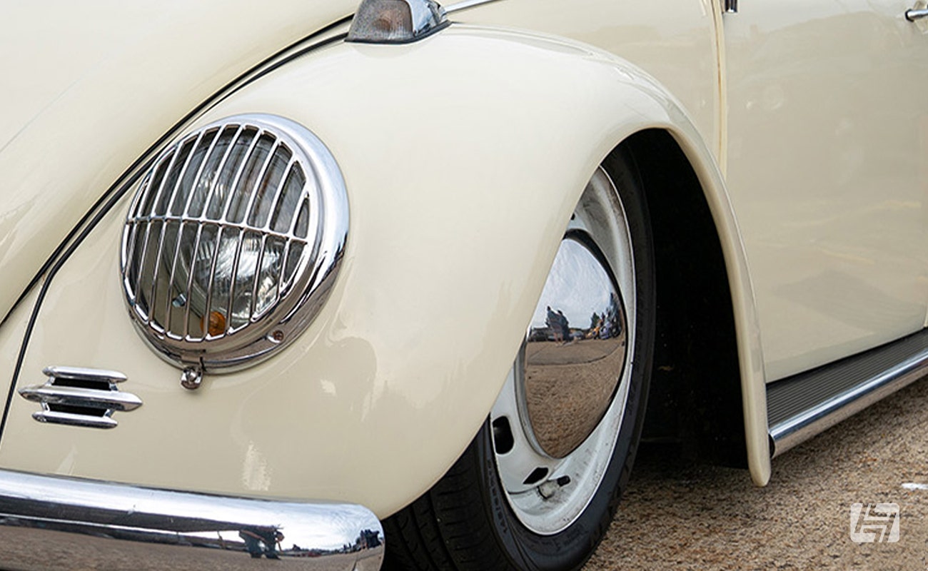 White VW Beetle with narrowed front axle fitted, showing the wheels tucked inside the arches