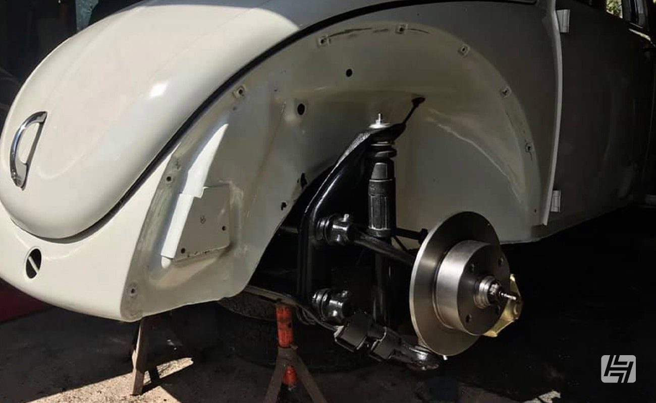 VW Beetle without front wing fitted, showing front axle, spindle and disc brakes