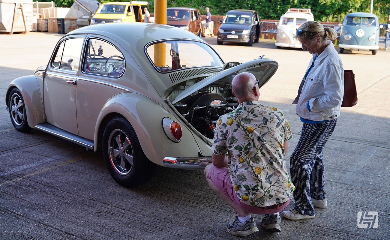 Man and Woman looking at VW Beetle engine bay at Heretics at Heritage Parts Centre in June 2024