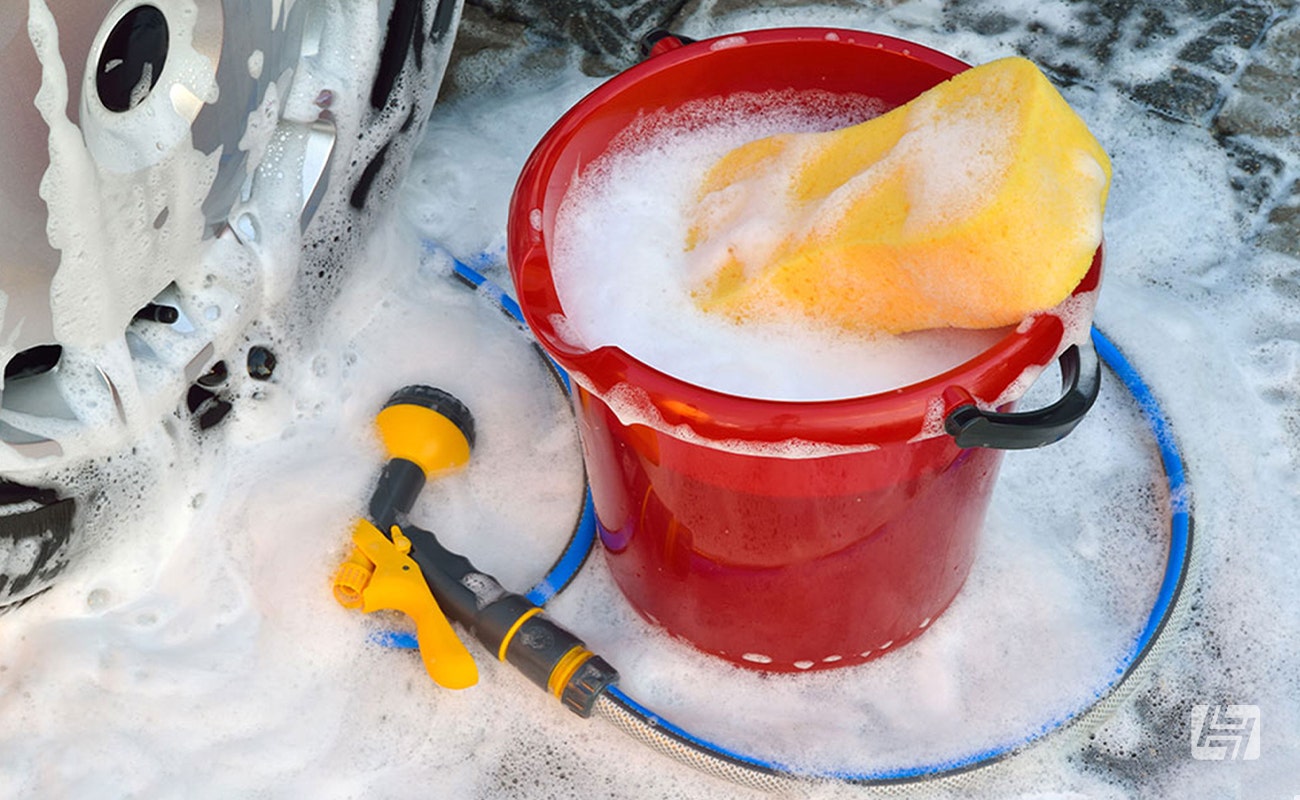 Bucket of soapy water and hose and sponge