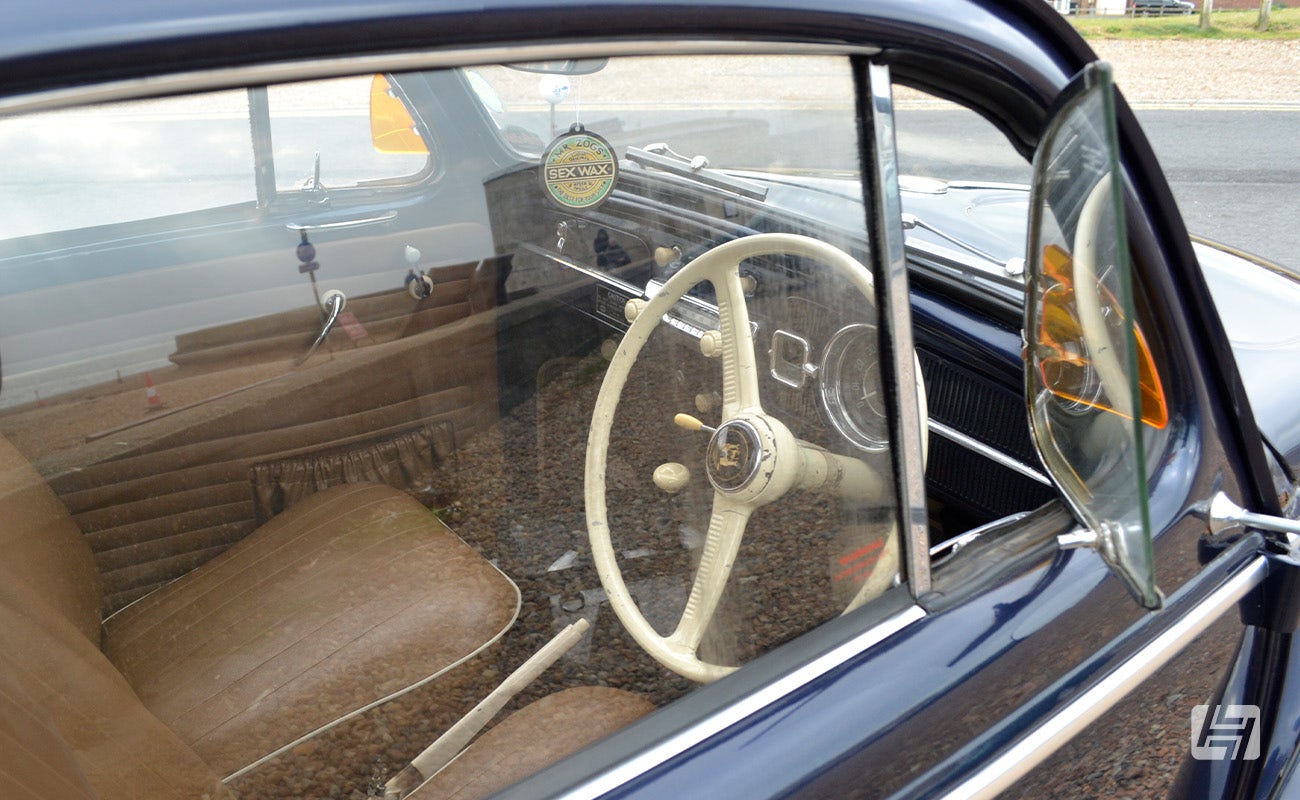 Blue VW Beetle with the front quaterlight window open