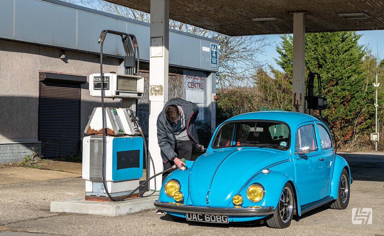 Filling up the fuel tank on a blue VW Beetle