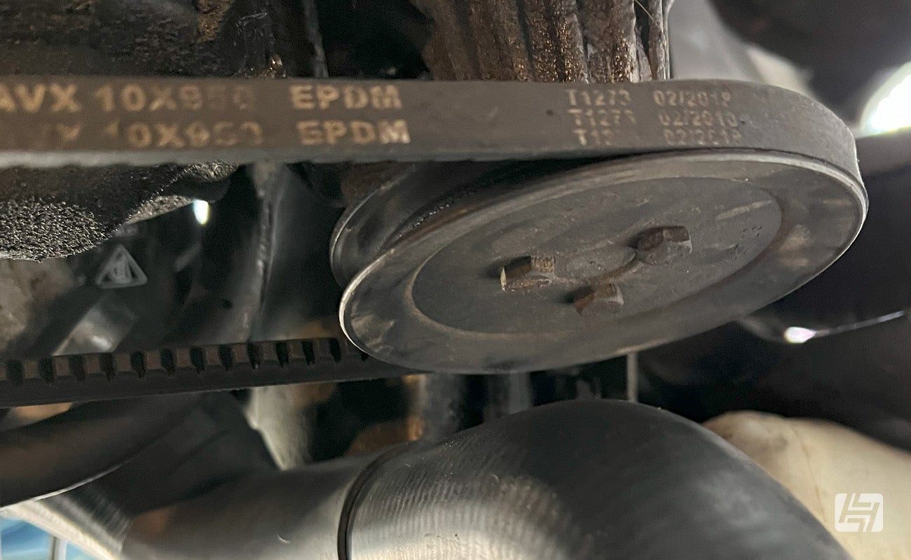 car drive belt with numbers printed on it, illustrating the belt size.