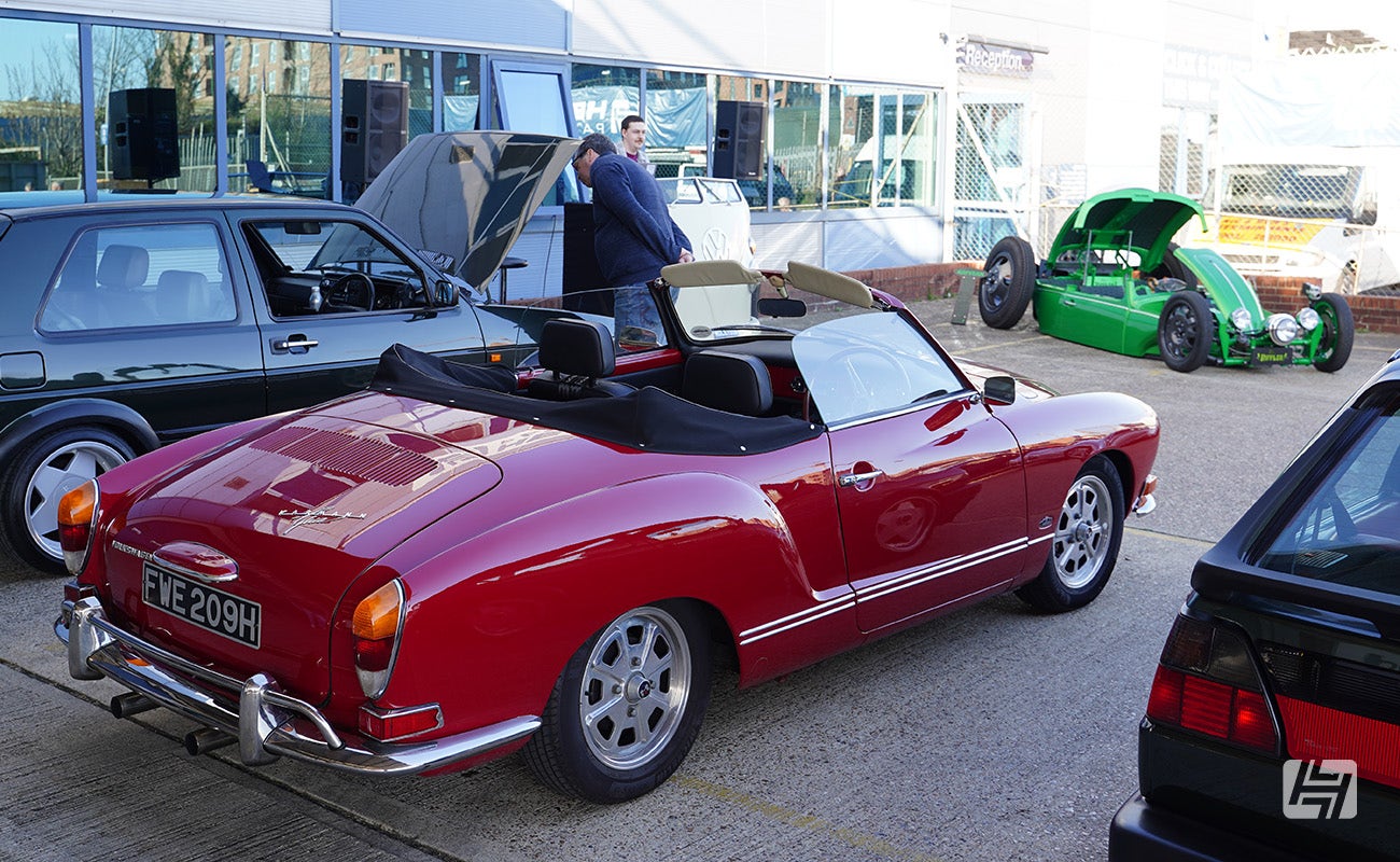 Red Karmann Ghia cabriolet at Heretics April 2025 Meeting at Heritage Parts Centre