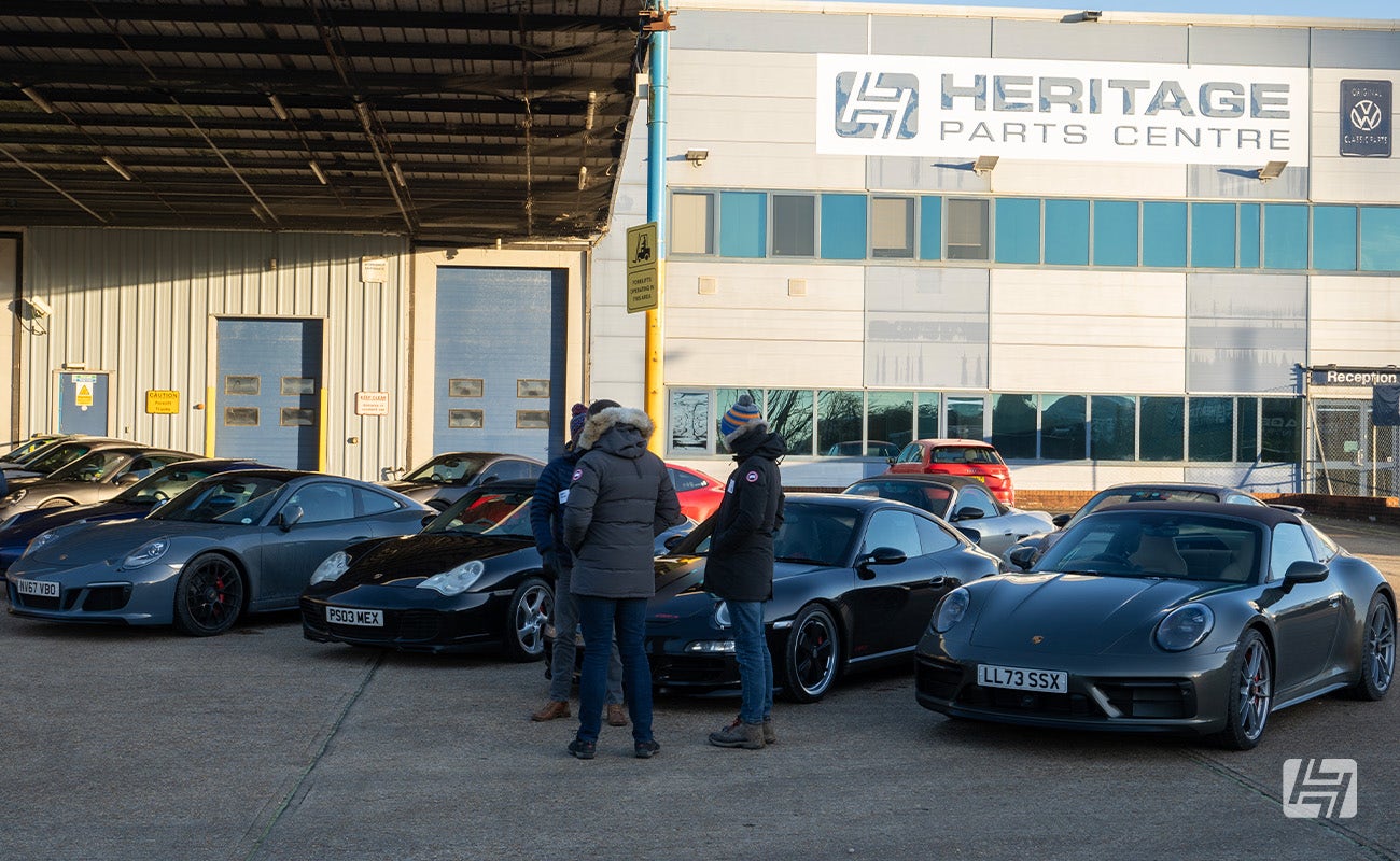Porsches parked outside at Heritage Parts Centre 9Werks warehouse meet