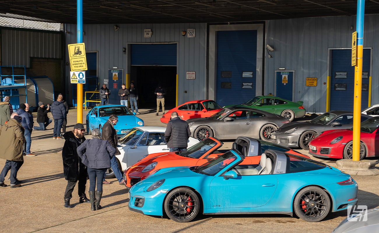 Porsches parked outside at Heritage Parts Centre 9Werks warehouse meet