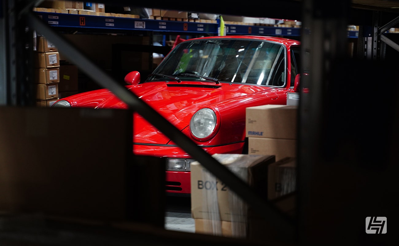 Abstract shot of red Porsche 964 at Heritage Parts Centre 9Werks warehouse meet