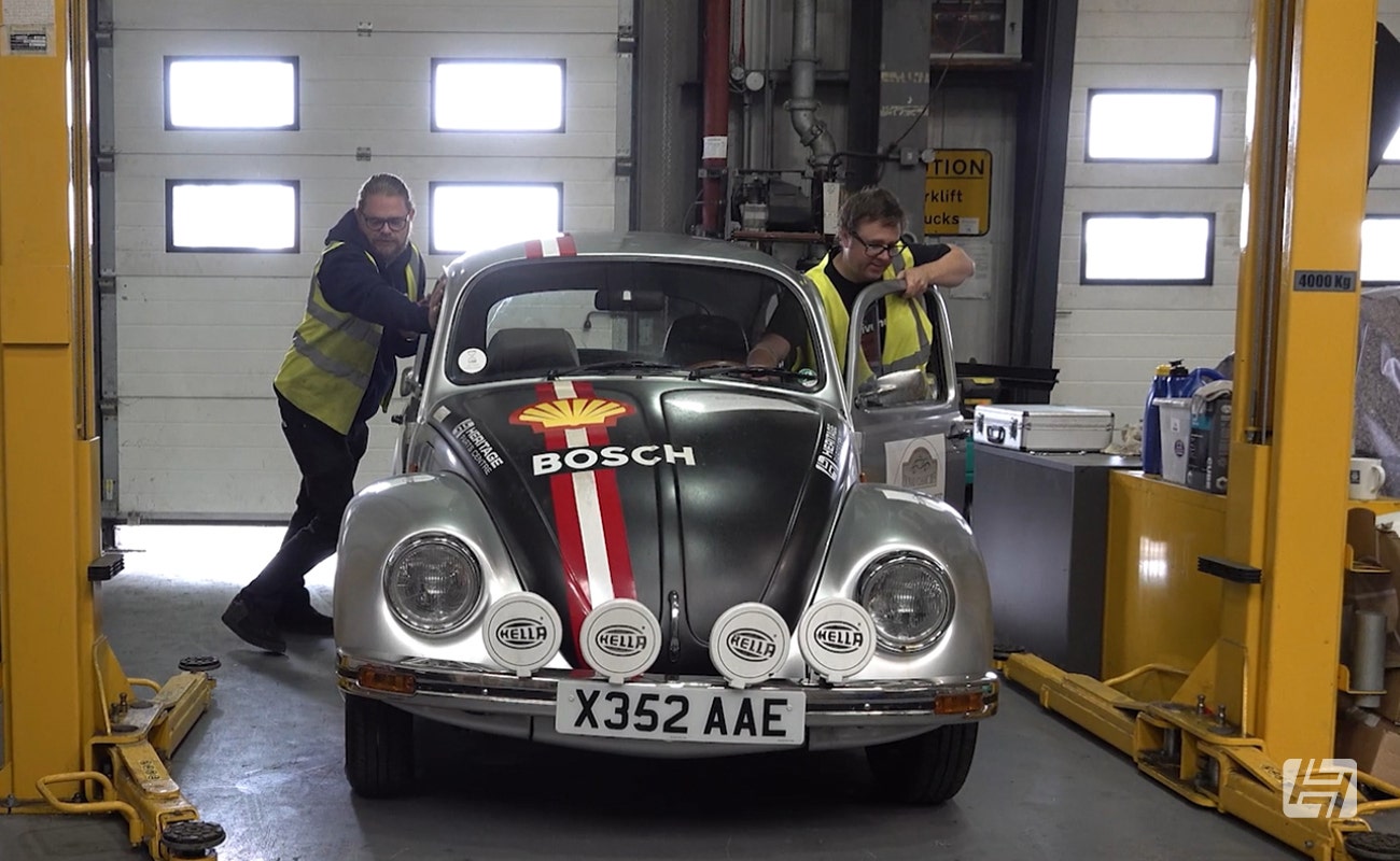 Chris and Andy from Heritage Parts Centre push the Rally Beetle in the workshop