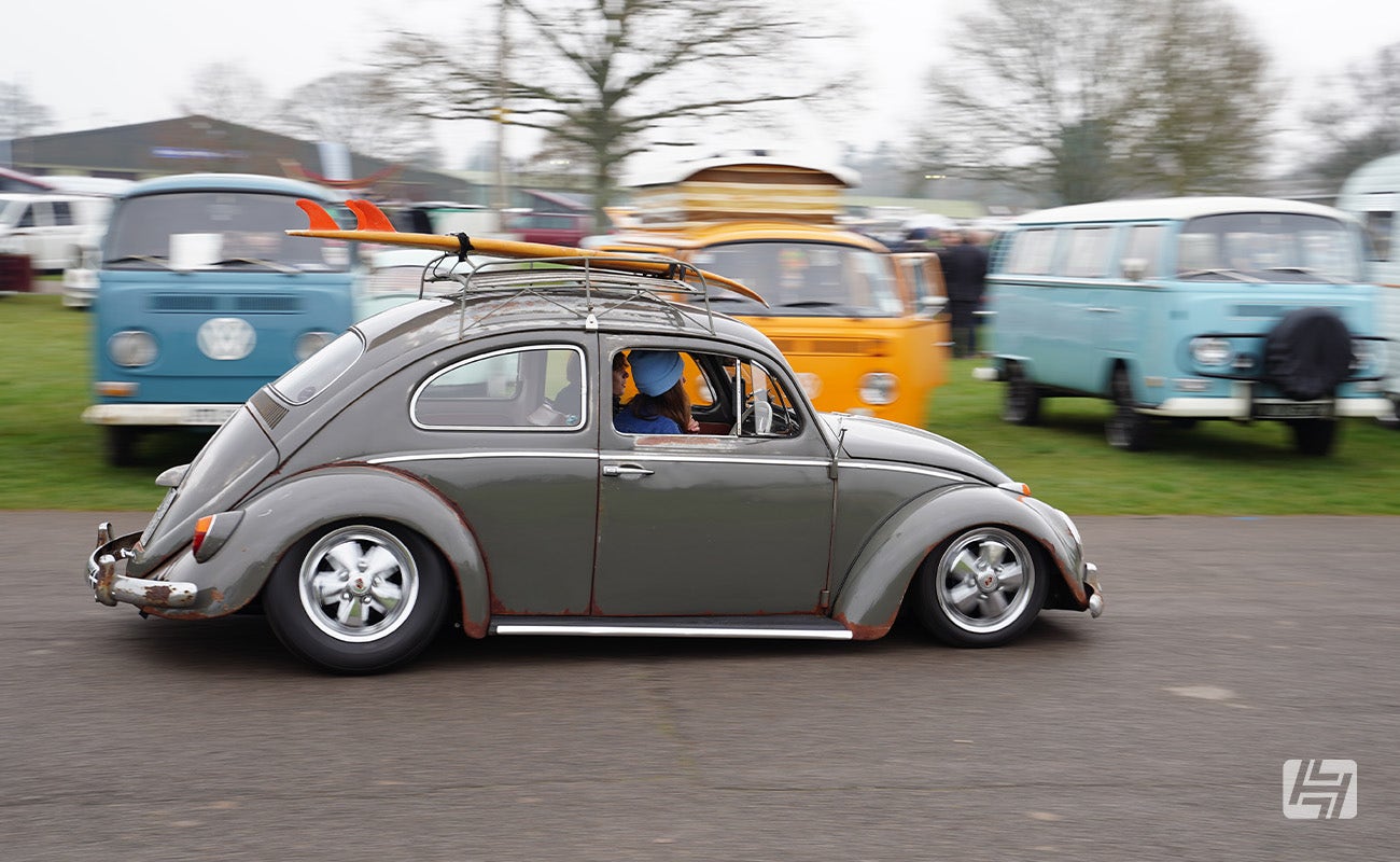 Grey patina VW Beetle driving at Volksworld 2025